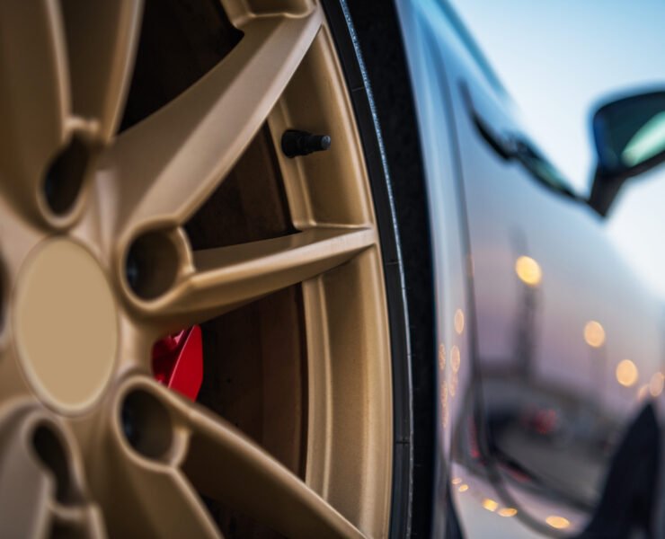Side Rear View Of Exotic Luxurious Sports Car And Tire With Golden Color Rim.