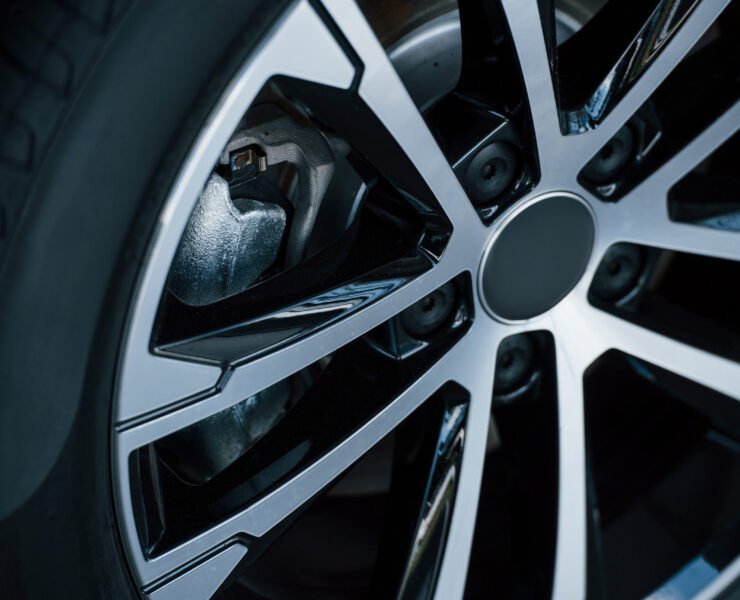 Detailed view of wheel of modern new car. Silver colored discs.