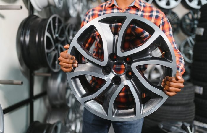 African american buyer chooses new alloy wheels for his car